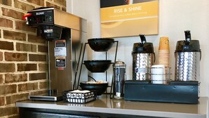 A coffee station with a Bunn espresso machine, a coffee grinder, and various coffee containers. - Motel 6 Hillsville, VA (Hillsville)