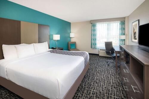 Premium bedding, desk, laptop workspace, iron/ironing board