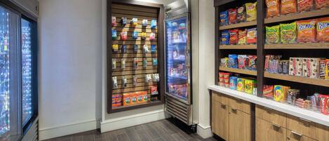 A snack bar with refrigerated and non-refrigerated snack options, including chips and cereals.
