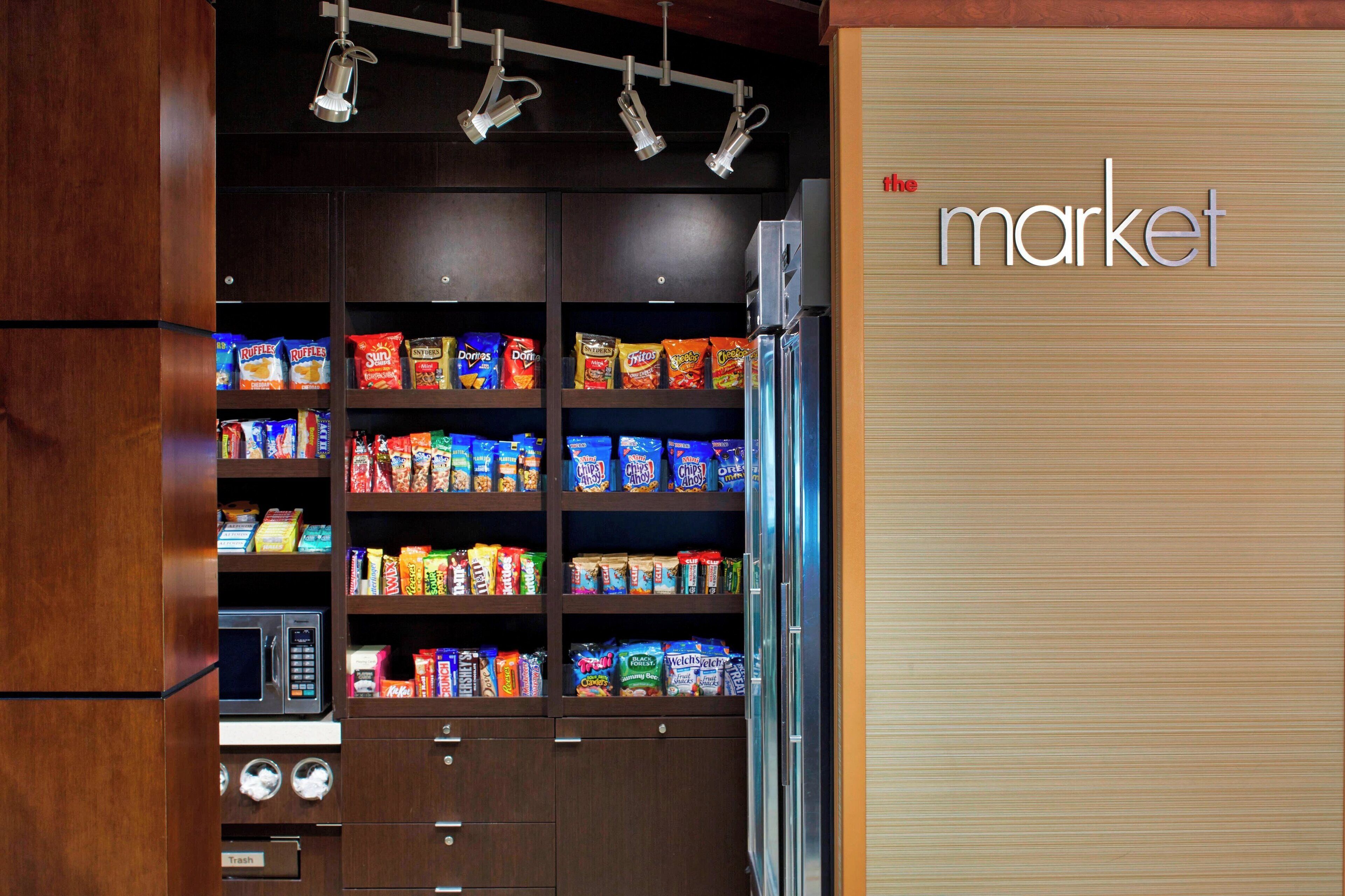 A vending machine area with snacks and a microwave.