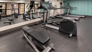 A gym with treadmills, ellipticals, and weight machines.