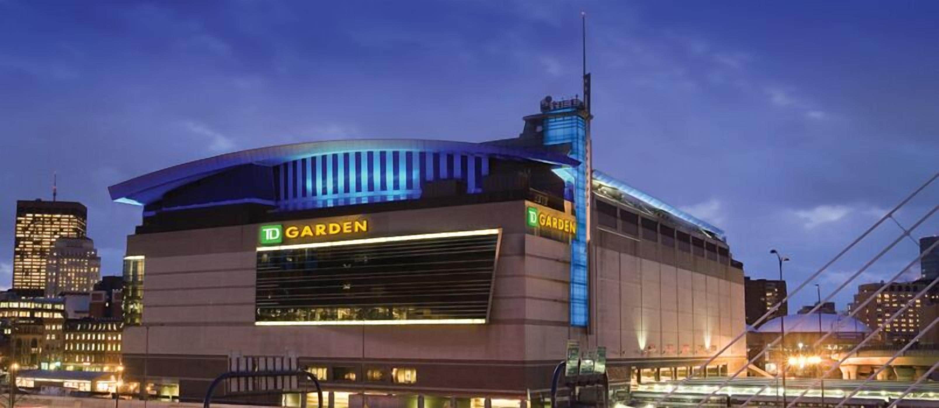 A modern building with a curved roof and a prominent 'TD GARDEN' sign.
