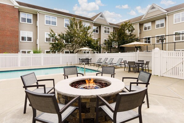 Relax by the fire pit surrounded by comfortable seating and enjoy access to a nearby pool.