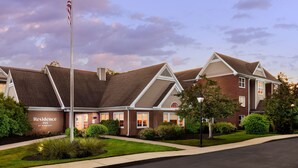 A brick building with a flagpole and a sign that reads "Residence Inn by Marriott." - Residence Inn by Marriott Foxborough (Foxborough)