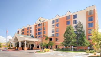 A multi-story hotel with a prominent entrance and a covered area.