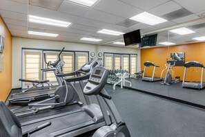 A gym with various exercise equipment, including treadmills and stationary bikes, and a large mirror on one wall. - Country Inn & Suites by Radisson, Mesa, AZ (Mesa)