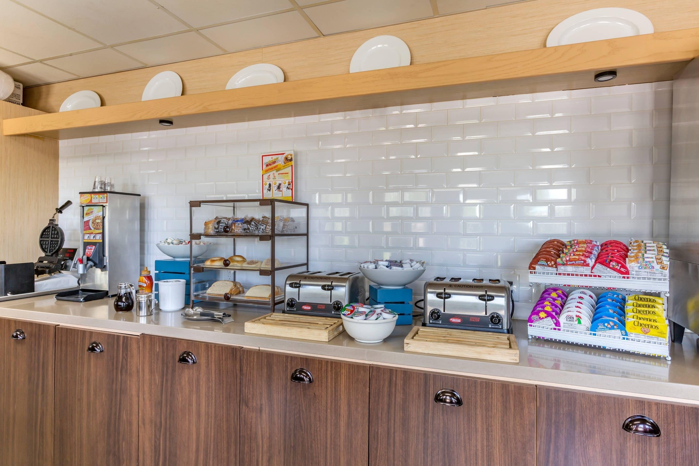 A breakfast bar with a coffee machine, toaster, and cereal display.