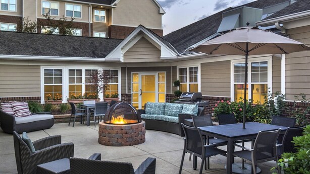An outdoor patio with a fire pit, seating, and a grill area. - Residence Inn Cranberry Township Pittsburgh by Marriott (Warrendale)