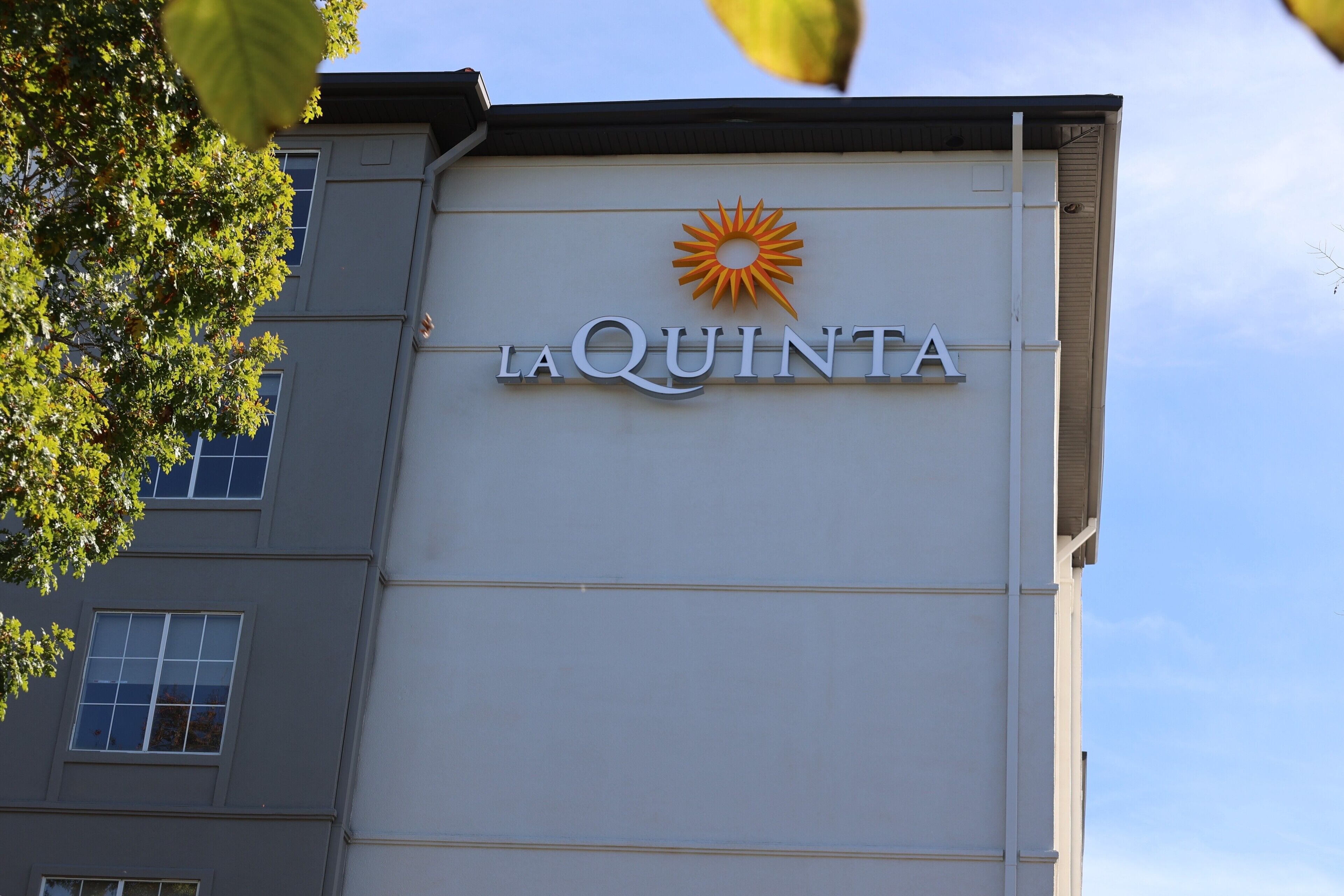 A building with a sign reading "LA QUINTA" and a sun symbol above the text.