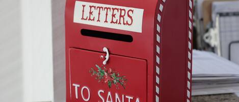 A red mailbox with "LETTERS TO SANTA" written on it.