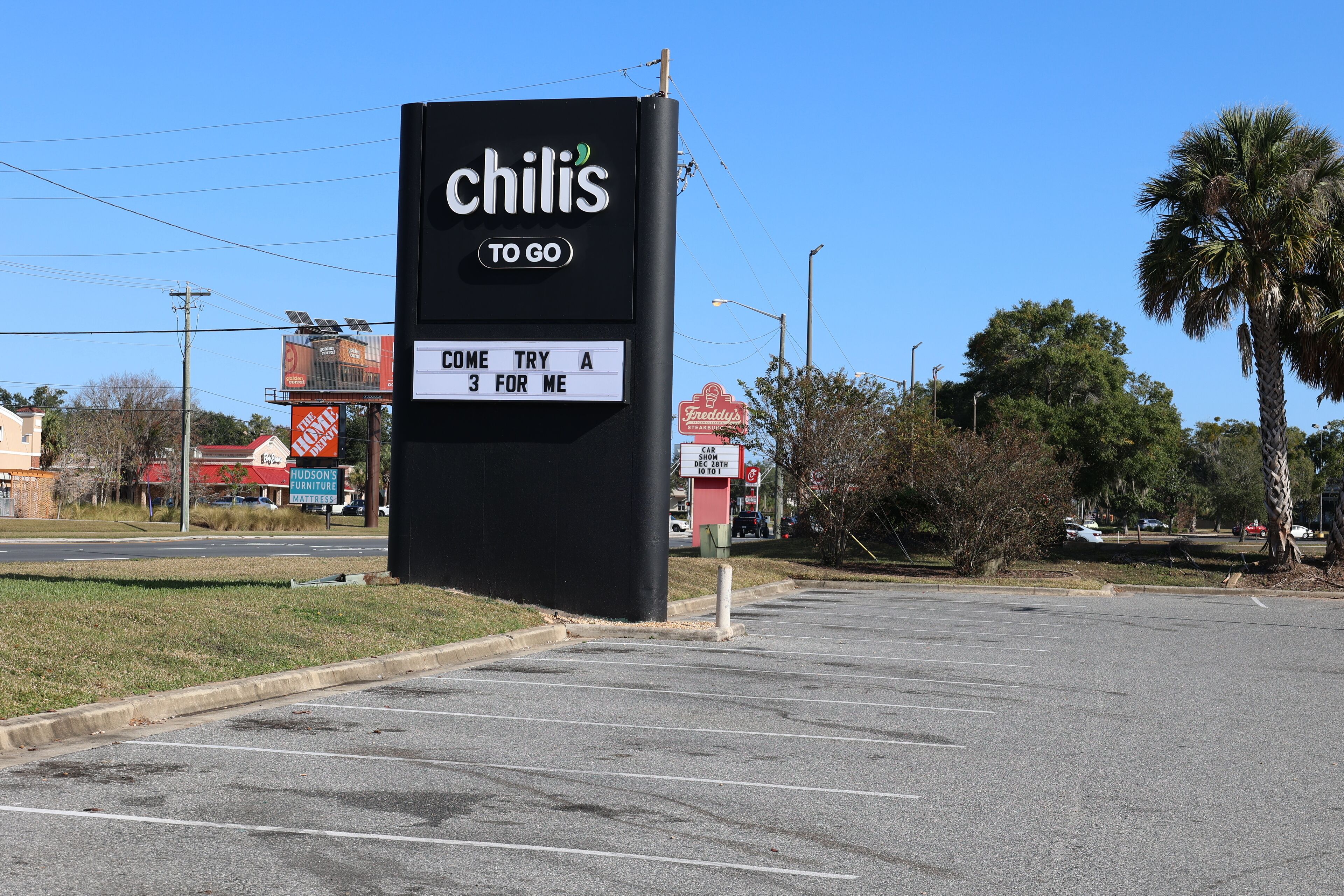 A parking lot with a sign for Chili's restaurant.