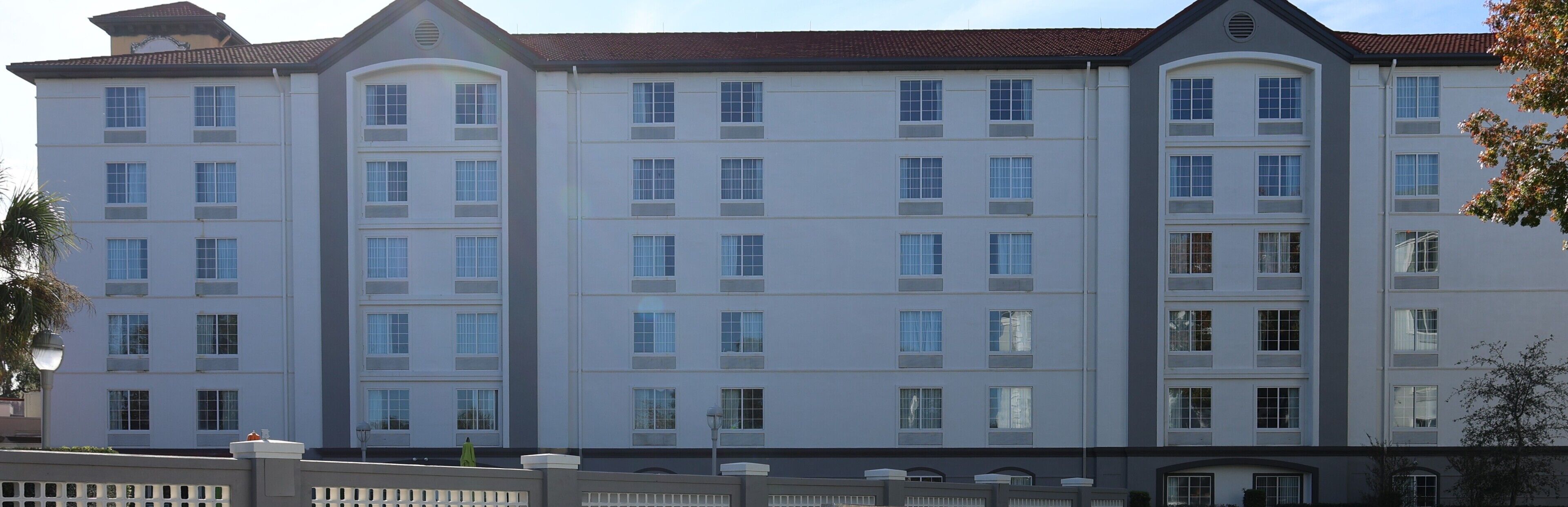 A multi-story hotel with a symmetrical facade, large windows, and a flat roof.