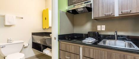 A bathroom with a toilet, sink, and towel rack.