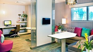 A modern hotel room with a desk, computer, seating area, and large windows. - Residence Inn by Marriott Hanover Lebanon (Lebanon)