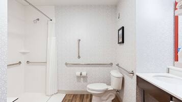 Un baño con ducha, inodoro y lavamanos.