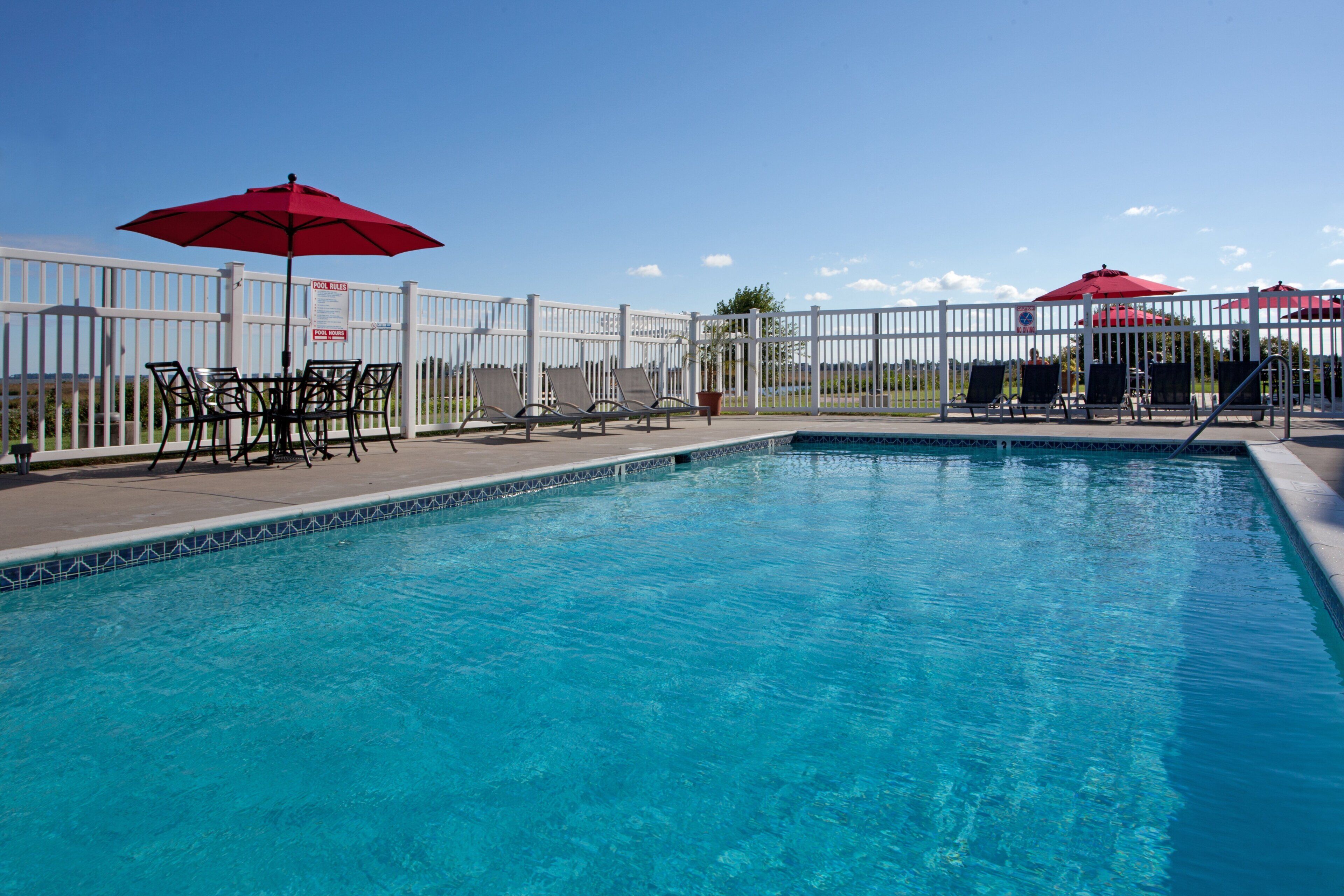 Seasonal outdoor pool, open 9 AM to 9 PM, pool umbrellas, pool loungers