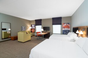 A hotel room with a large bed, a desk, a chair, a sofa, and a television. - Hampton Inn Madison Huntsville Airport (Madison)