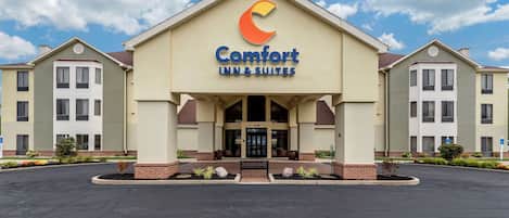 A Comfort Inn & Suites building with a prominent logo, a central entrance, and a parking lot.