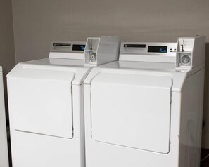 Two white front-loading washing machines with digital displays.