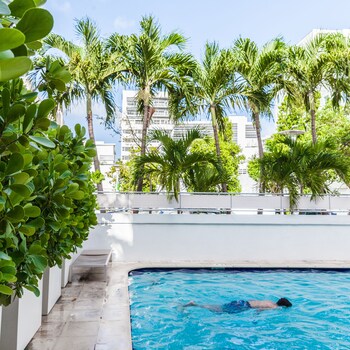 Outdoor pool, open 9:00 AM to 5:00 PM, pool umbrellas, sun loungers at Crest Hotel Suites