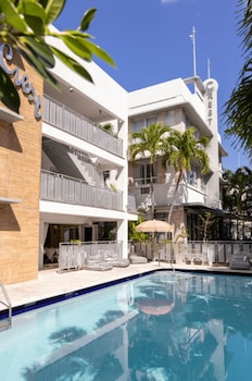 Outdoor pool, open 9:00 AM to 5:00 PM, pool umbrellas, sun loungers at Crest Hotel Suites