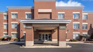 A brick building with a covered entrance labeled "Lobby" and the number "855" on the facade.