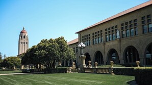 A building with a clock tower, arched windows, and a well-maintained lawn. - Holiday Inn Express Suites Belmont by IHG (Belmont)