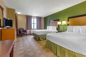 A hotel room with two beds, a desk, a chair, a television, and a window with curtains. - Extended Stay America Select Suites - Phoenix - Deer Valley (Phoenix)