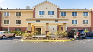 A multi-story hotel with a beige facade, a central lobby, and a parking area with no parking signs. - Extended Stay America Suites Philadelphia Bensalem (Bensalem)