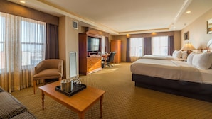 A hotel room with a bed, a desk, a chair, a television, and a window with curtains. - Ambassador Hotel Milwaukee, Trademark Collection by Wyndham (Milwaukee)