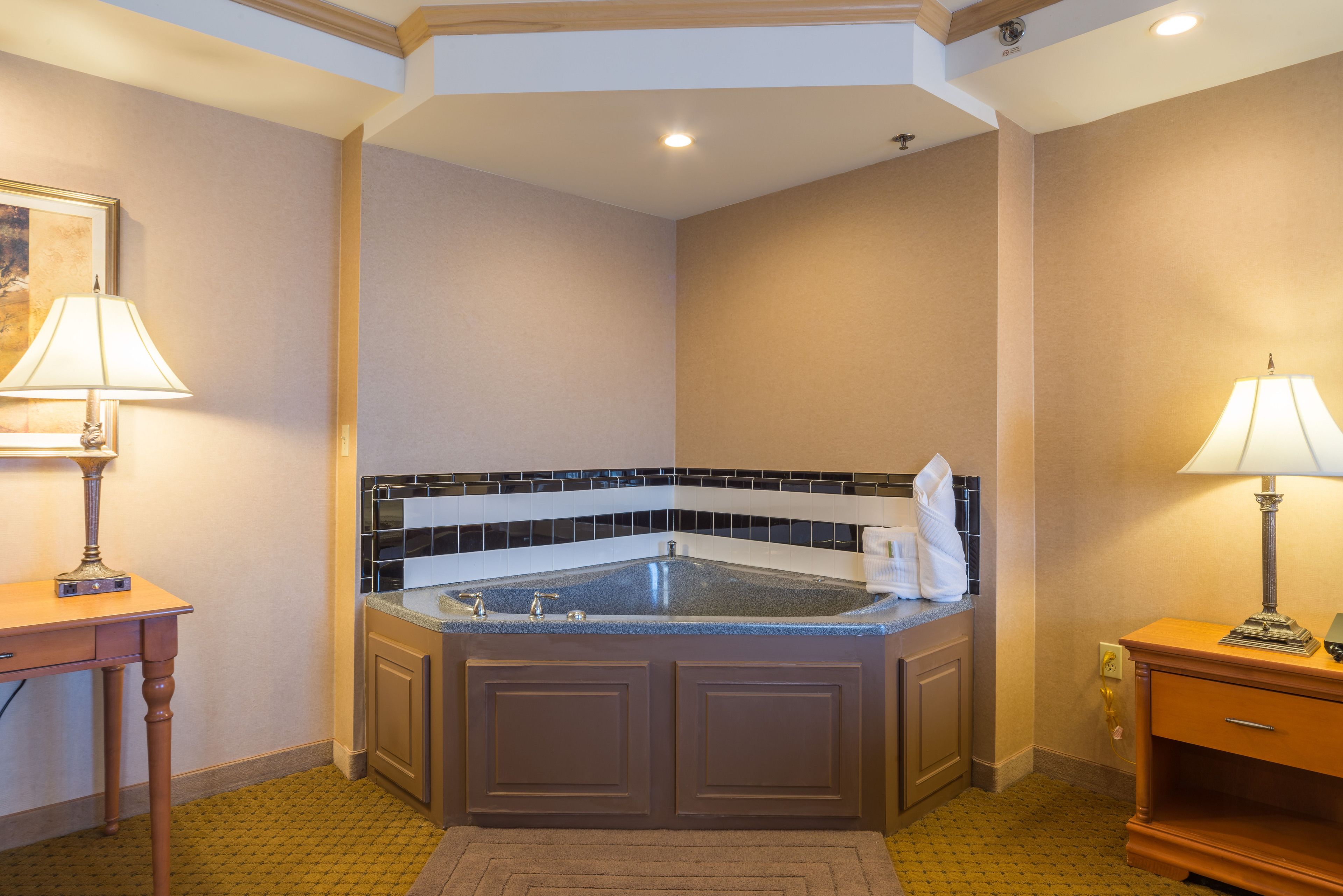 A bathroom with a freestanding bathtub, a vanity with a mirror, and a wall-mounted towel rack.