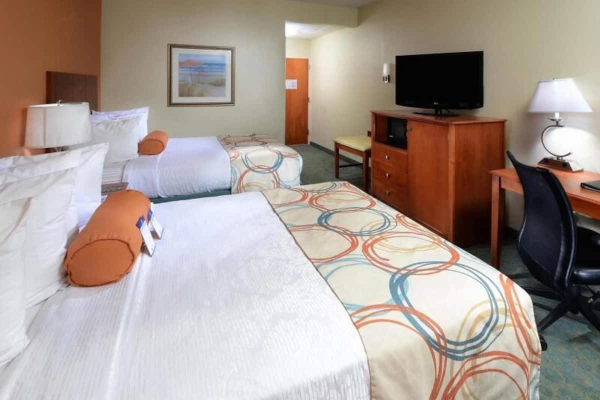 Premium bedding, desk, laptop workspace, blackout drapes