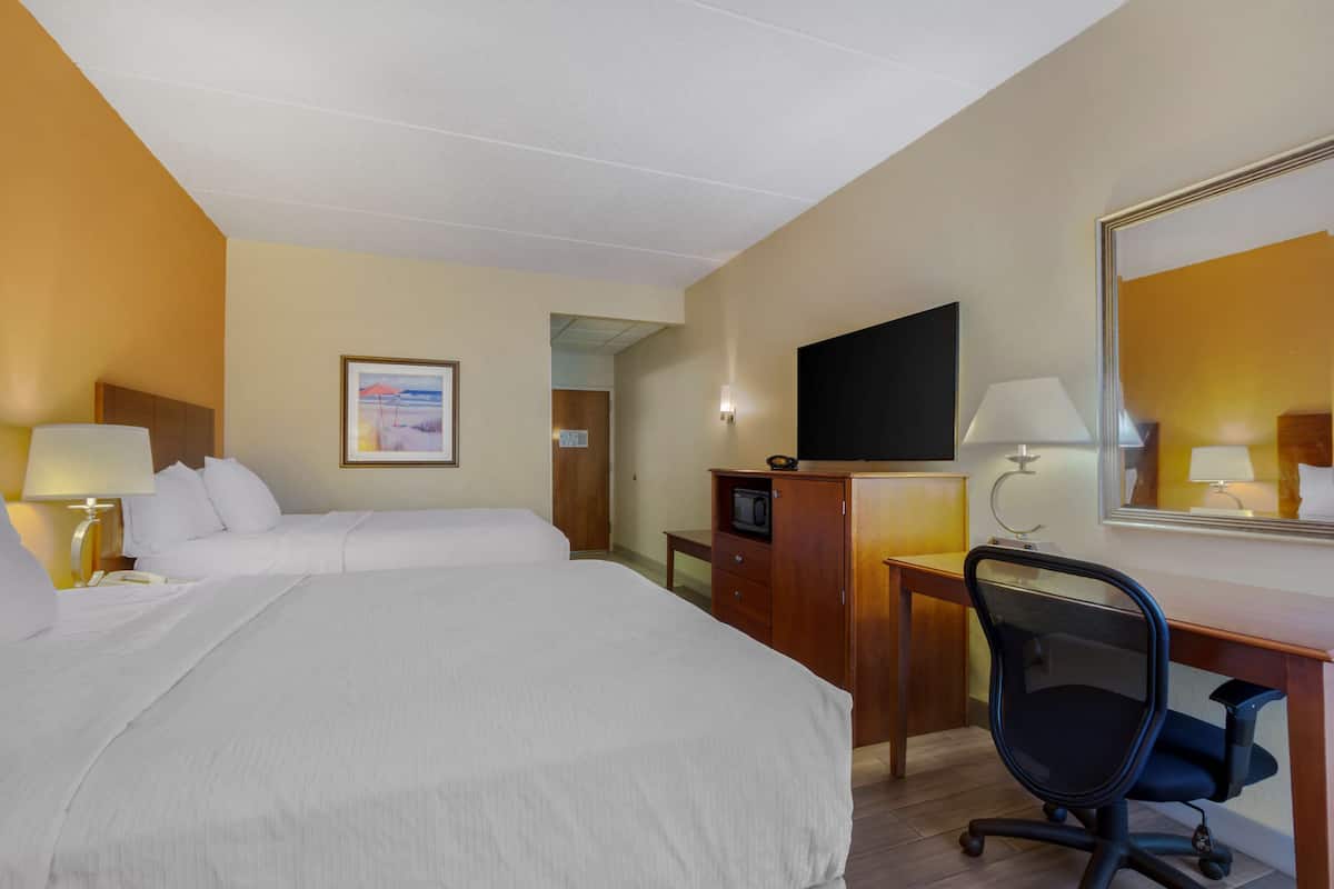 Premium bedding, desk, laptop workspace, blackout drapes