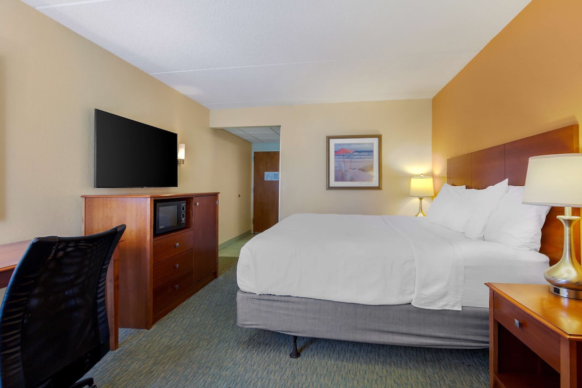 Premium bedding, desk, laptop workspace, blackout drapes