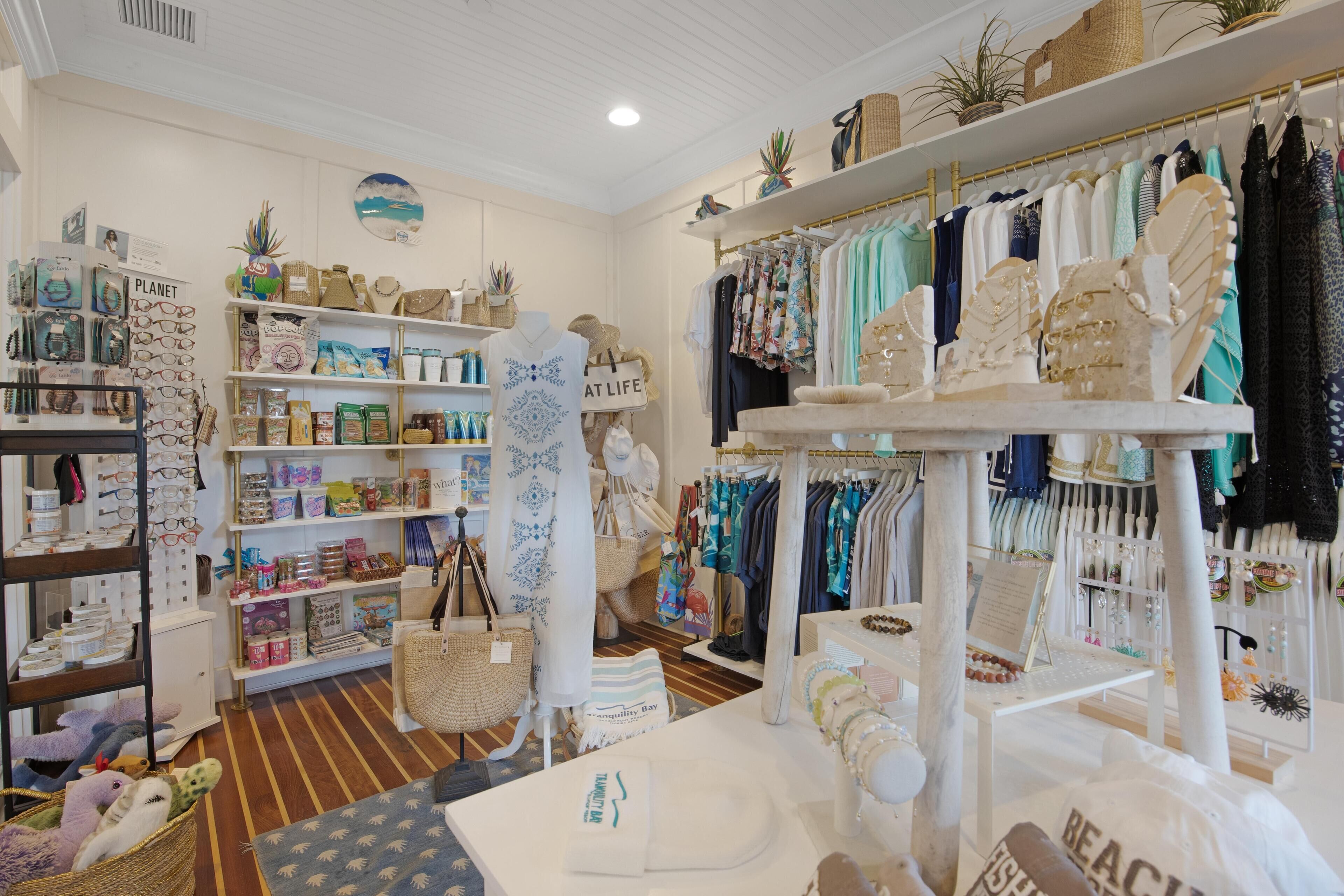 A boutique store with shelves of clothing and accessories, a display of hats, and a sign that reads "Planet".