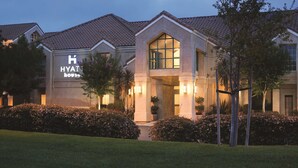 A hotel with a prominent 'HYATT' sign, large windows, and well-maintained landscaping. - HYATT house Pleasanton (Pleasanton)