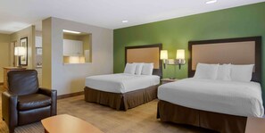 A hotel room with two beds, a chair, a desk, and a kitchenette. - Extended Stay America Suites Orlando Theme Parks Vineland Rd (Orlando)