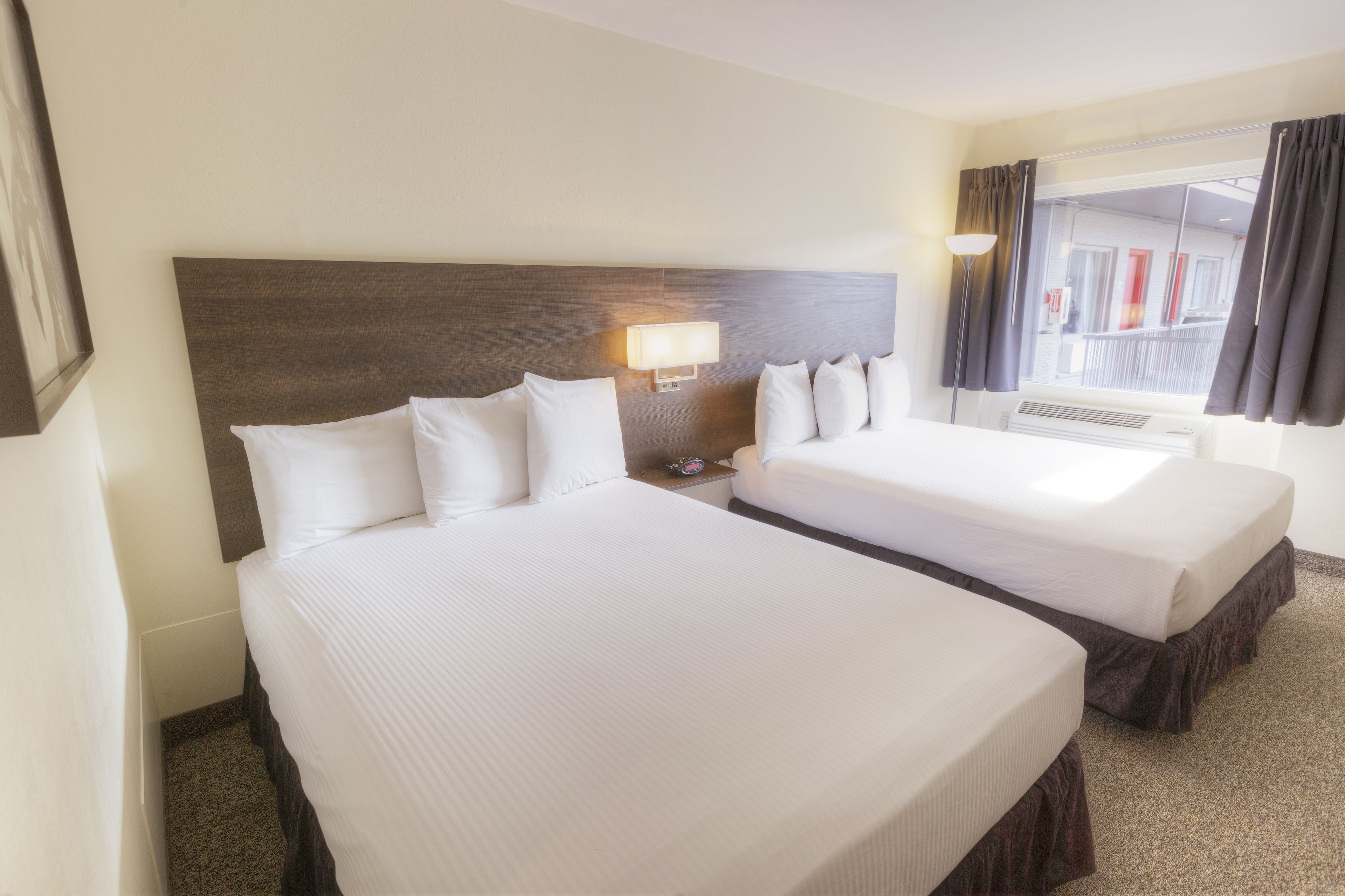 premium bedding, pillow-top beds, desk, laptop workspace