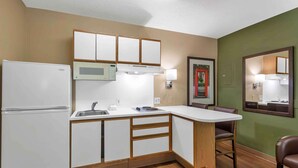 A compact kitchen with a refrigerator, microwave, and sink. - Extended Stay America Suites Nashville Airport Music City (Nashville)