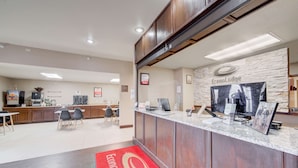 A hotel reception area with a counter, seating area, and a kitchenette. - Econo Lodge Livingston Gateway to Yellowstone (Livingston)