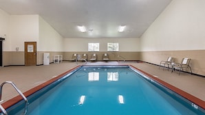 A large indoor swimming pool with a clear view of the ceiling, a chemical storage area, and several windows. - Econo Lodge Livingston Gateway to Yellowstone (Livingston)