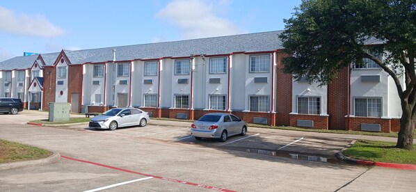 Stylish building with a flat roof and multiple windows, some with awnings.