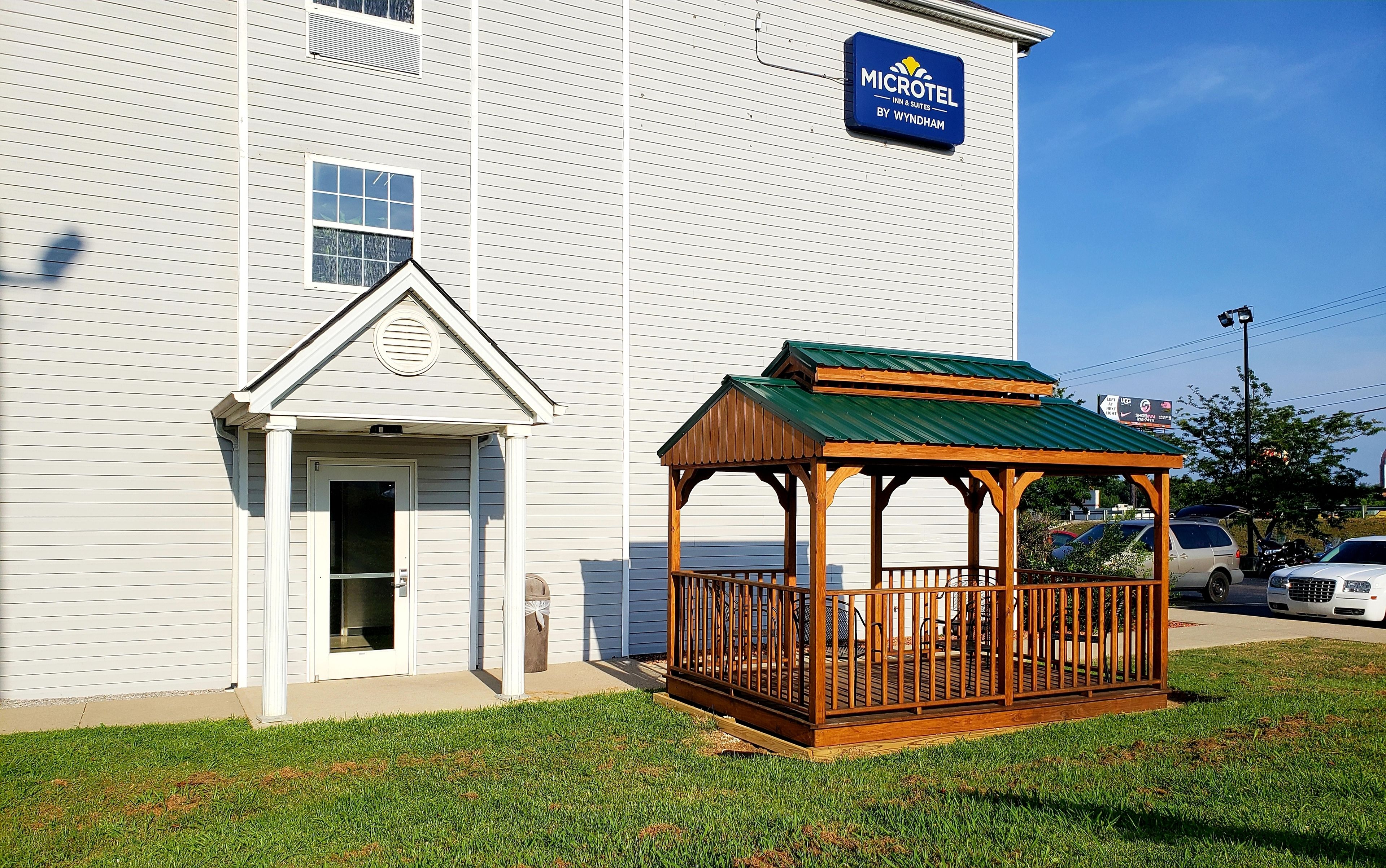 A white building with a blue sign for Microtel Inn & Suites by Wyndham.