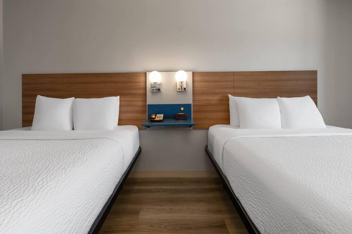 Standard Room, 2 Queen Beds | Desk, travel crib, WiFi (free), bed sheets