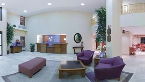 A spacious lobby with a reception desk, seating area, and a dining section. - Holiday Inn Express Hotel & Suites Phoenix-Airport by IHG (Phoenix)