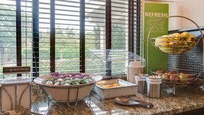 A buffet setup with various food items and utensils. - Hampton Inn Dickson (Dickson)