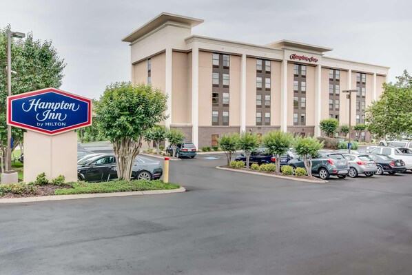 Experience the welcoming atmosphere of this Hampton Inn, featuring a symmetrical facade with a flat roof and beautifully landscaped surroundings.