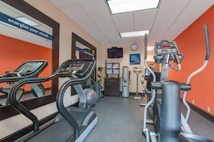 A gym with treadmills, an elliptical, and a stationary bike.