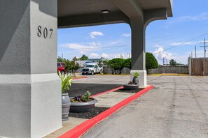 A parking area with a red curb, a building with the number 807, and a clear sky. - Quality Inn Cleveland, MS (Cleveland)