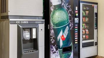A vending machine with a 7UP logo and a freezer compartment labeled 'ICE CUBES'.